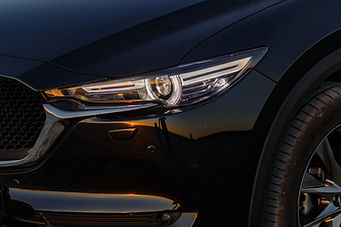 part-of-the-body-of-a-black-car-at-sunset-2023-11-27-05-06-30-utc.jpg