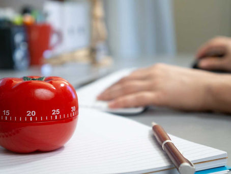 Student using the Pomodoro Technique to study multiple subjects with a timer, notebook, and to-do list on desk, boosting focus, productivity, and study motivation through 25-minute sessions and regular breaks