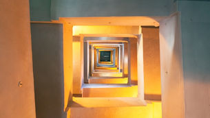 Looking up through a staircase, representing the next generation’s path to earning credibility and leadership in a family business.