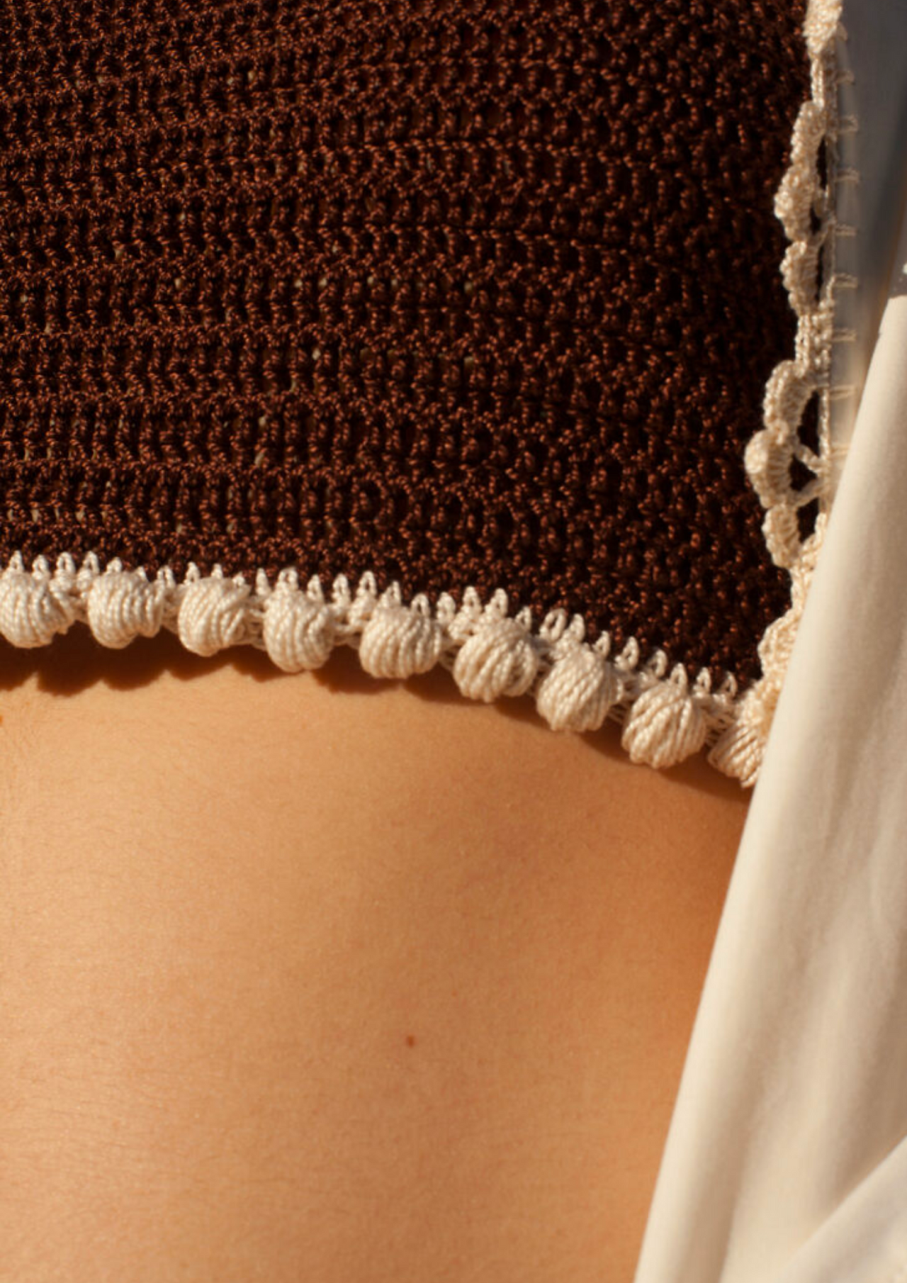 close up of cropped crochet top on skin