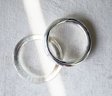 big silver bangle and transparent bangle with a ray of sun light