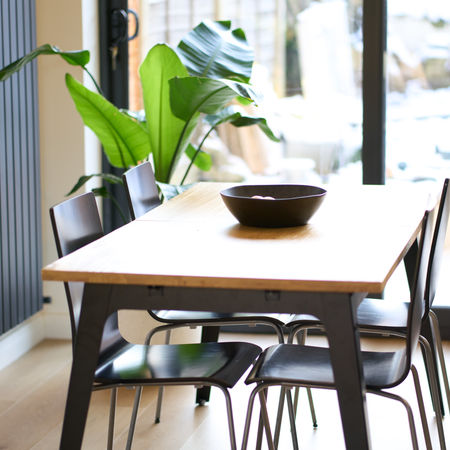 Dining area with black chairs and potted plants