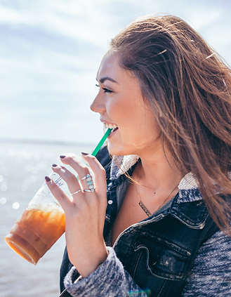 Girl drinking coffee on a lake