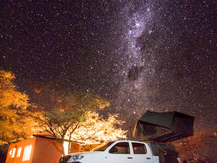 Stargazing from a rooftop tent in Namibia’s remote wilderness — a 4x4 under the Milky Way.