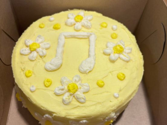 A cake decorated with flowers and a music note by a student in the Bev Facey Culinary Arts program.