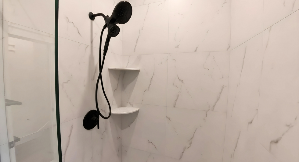 white tile modern shower with corner shelves