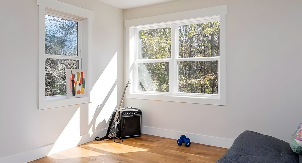 spare bedroom with futon couch and light hardwood floors