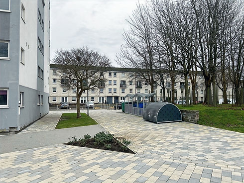 Glasgow housing courtyard with new block paving, access paths, bike store and planting beds.