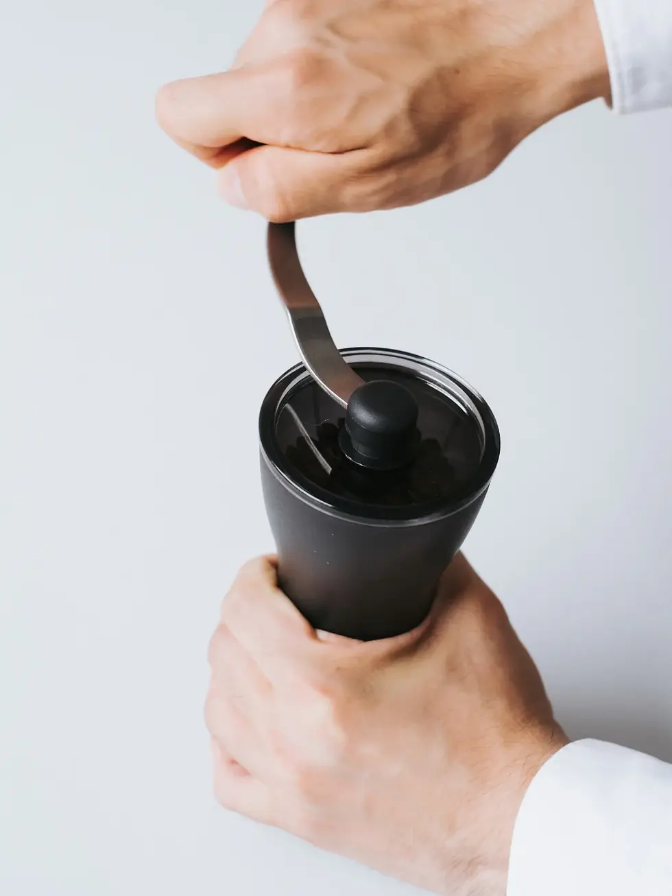 Thumbnail: Hand about to turn Hario Grinder