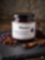 Jar of Meskari Saskatoon Spiced Rum Jam on a slate board surrounded by Saskatoon Berries. Alberta Made