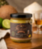A glass jar of Meskari Reserve Piña Colada Jam featuring a dark wood label and text Low Sugar. Made in Airdrie