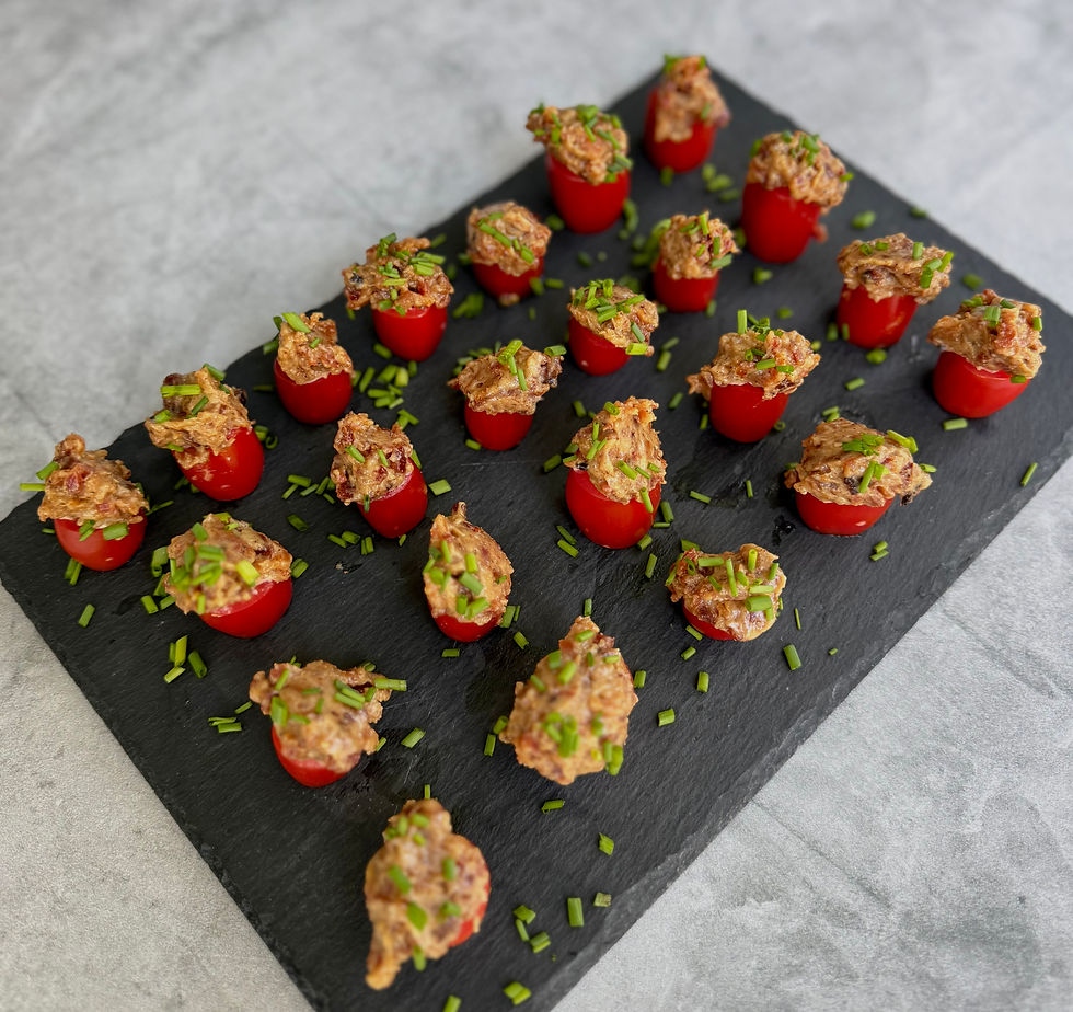 BLT Bites on a black serving platter with tomatoes mayonnaise bacon and fresh chives