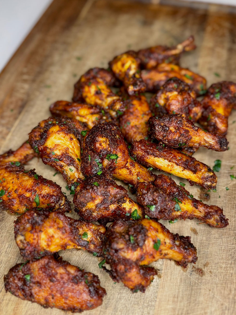 BBQ party wings on a wooden cutting board