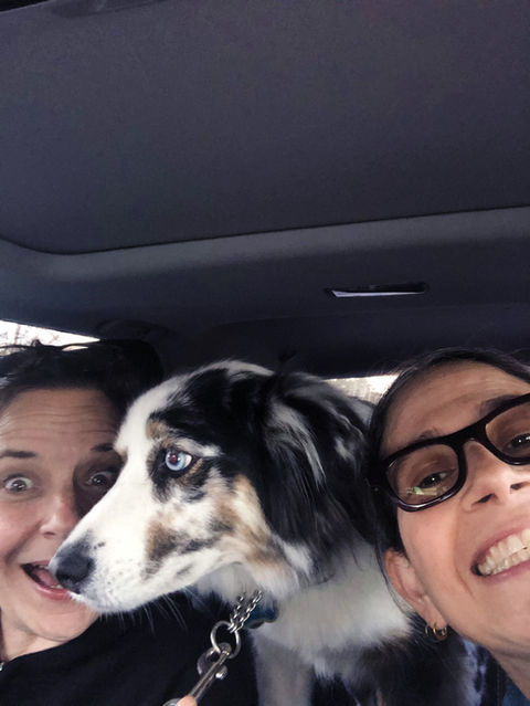 Abby and Laura in car with Australian shepherd Honeybear on leash