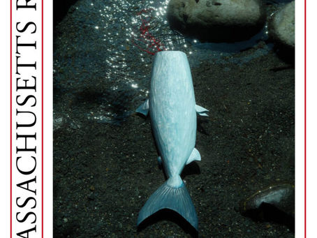 A magazine cover showing an artistic photo of a stylized blue fish or whale lying over a glittering stream with rocks. The magazine title of The Massachusetts Review is printed vertically up the lefthand side.