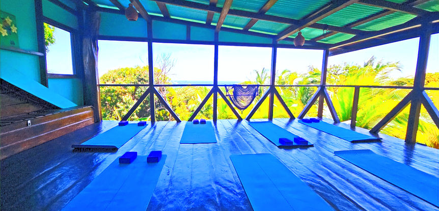 Ocean-view wooden rooftop yoga deck at The Lighthouse Retreat in Little Corn Island, Nicaragua.