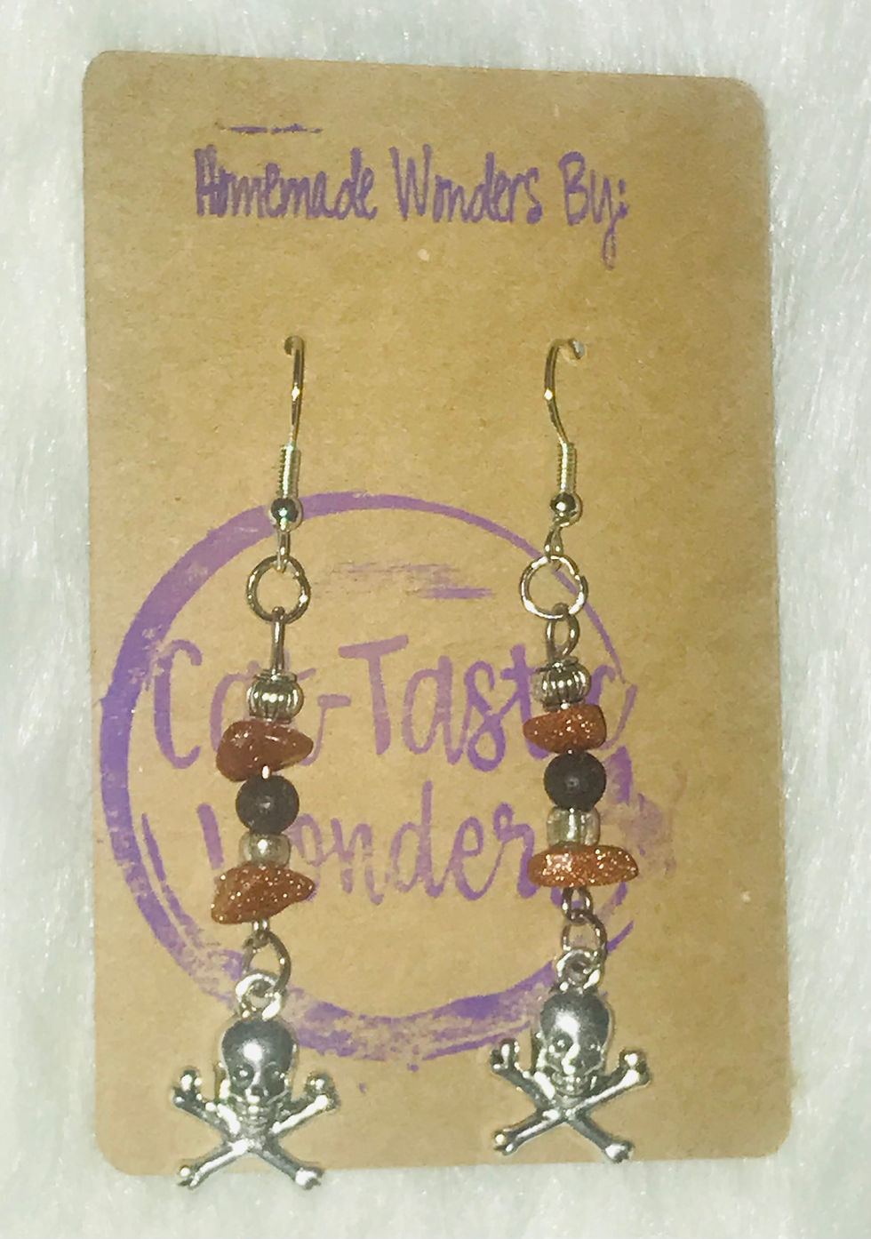 Earrings with text: Homemade Wonders By, Cat-Tastic Wonders, silver and gemstones.