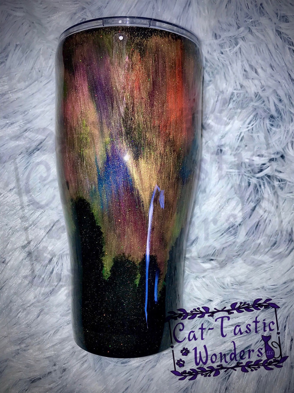 Colorful glitter tumbler with dark bottom and Cat-Tastic Wonders text printed on it.