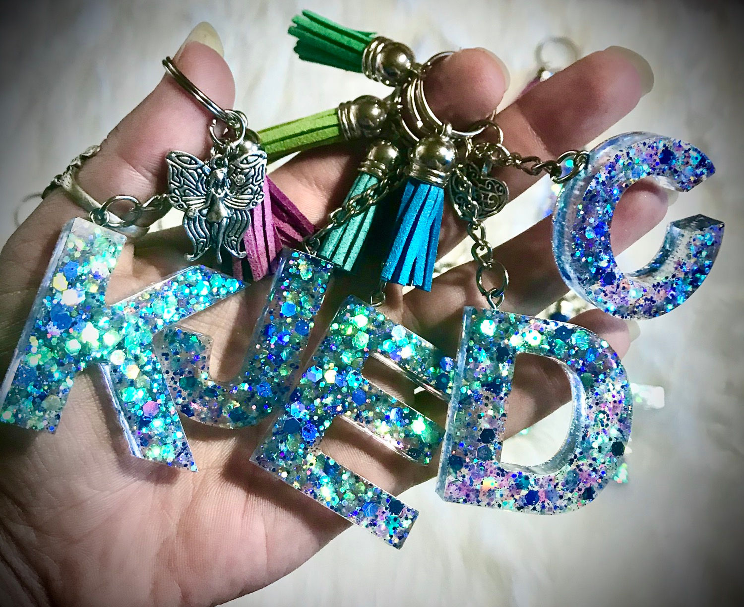 Hand holding name keychains: 
