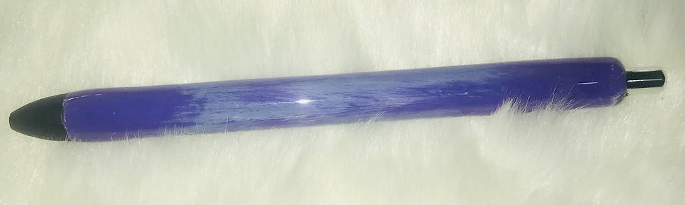 Close-up of a purple pen with light reflecting, sitting on white cloth.