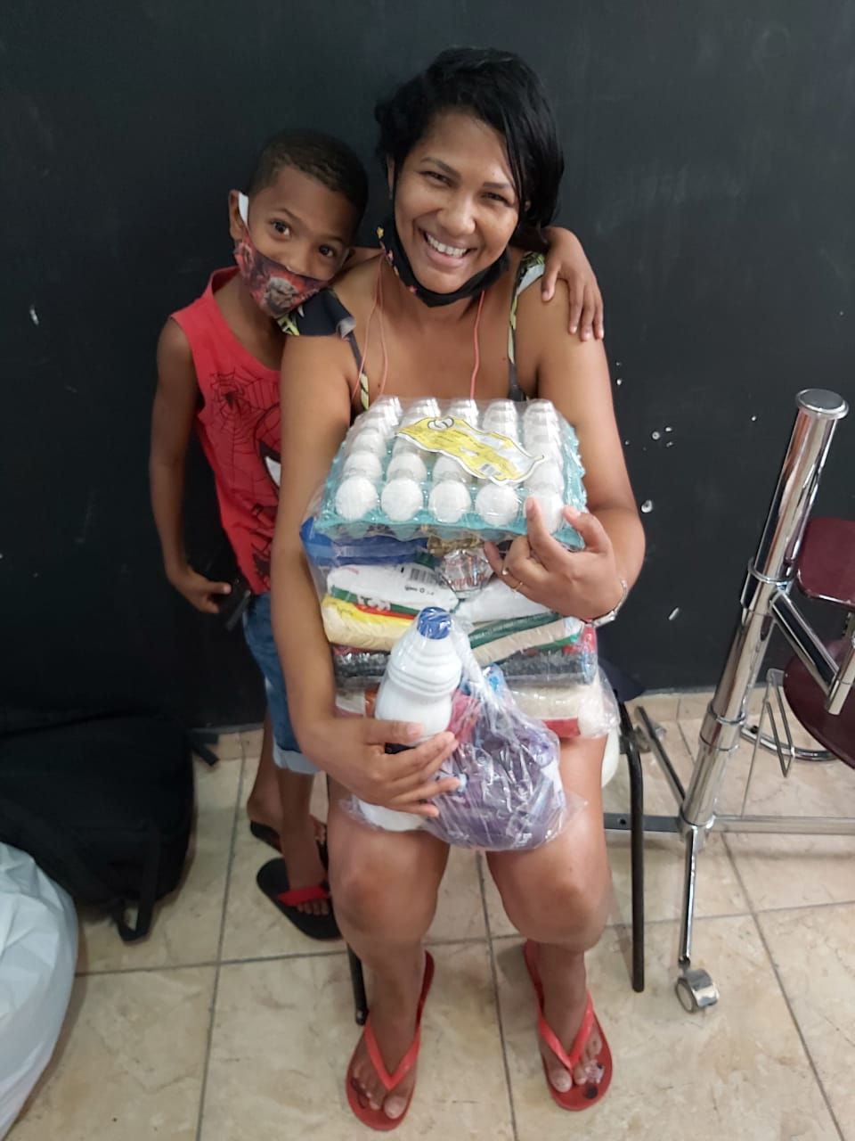 A mother and son pick up donated food from Hopeloft's new location in Rio de Janeiro.