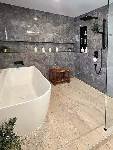 Freestanding white bathtub grey marble walls wooden stool