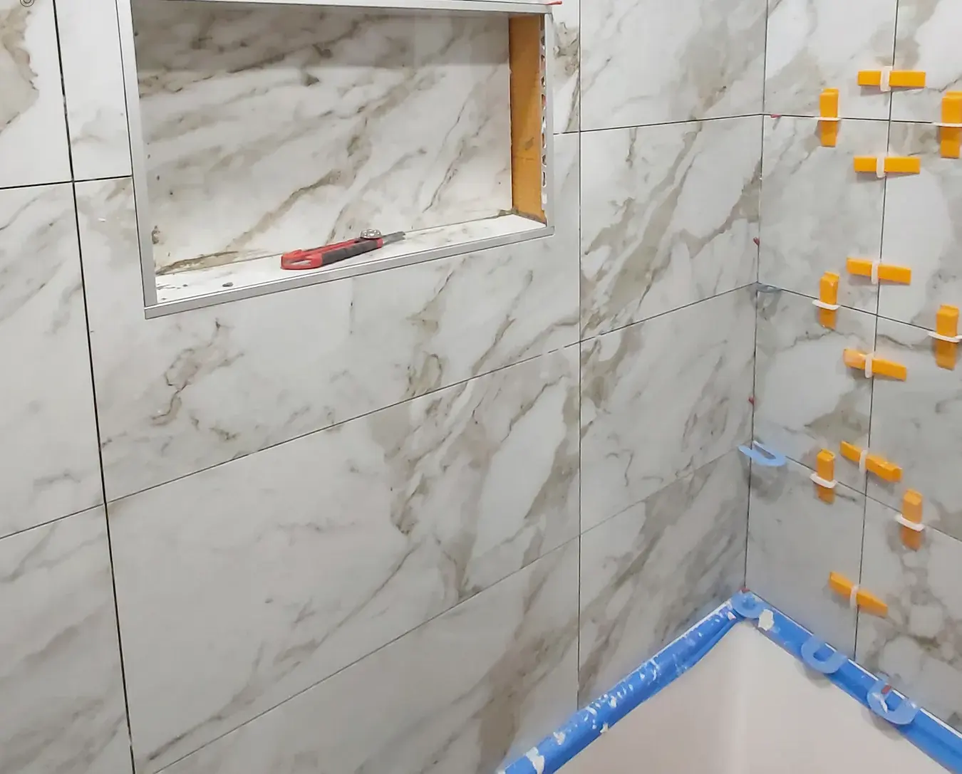 recessed shower niche marble tile surround dark accent band