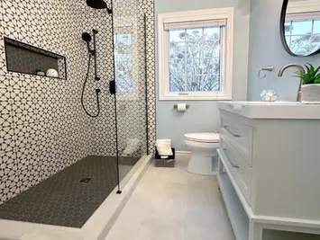 Patterned tile shower with blue walls.