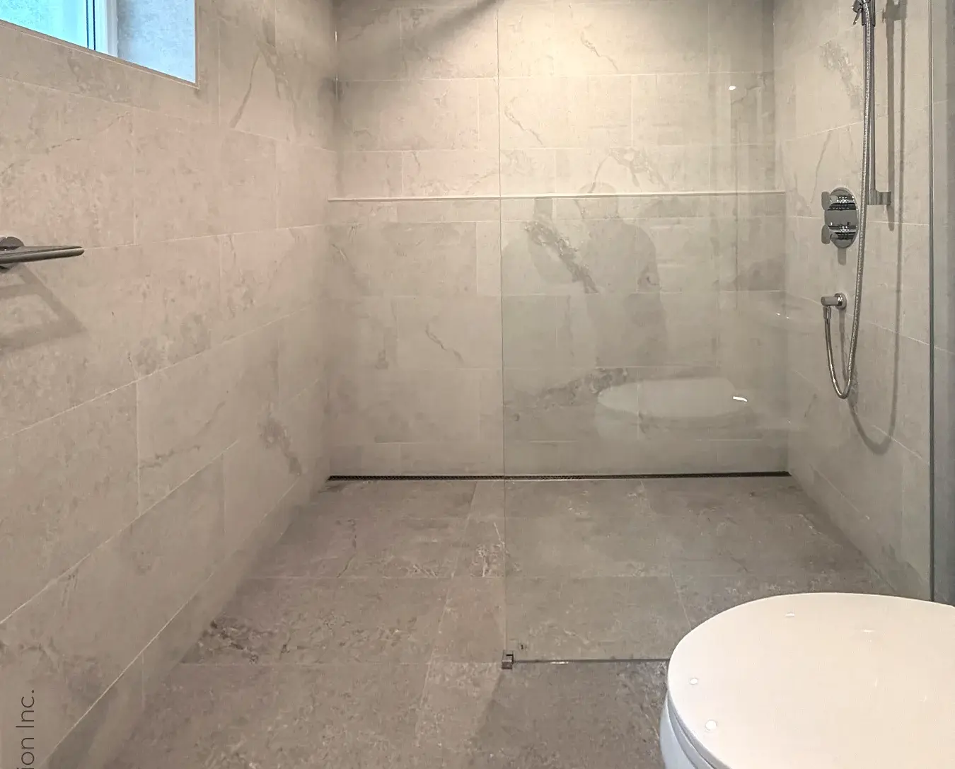 glass walk-in shower enclosure grey porcelain tile bathroom remodel