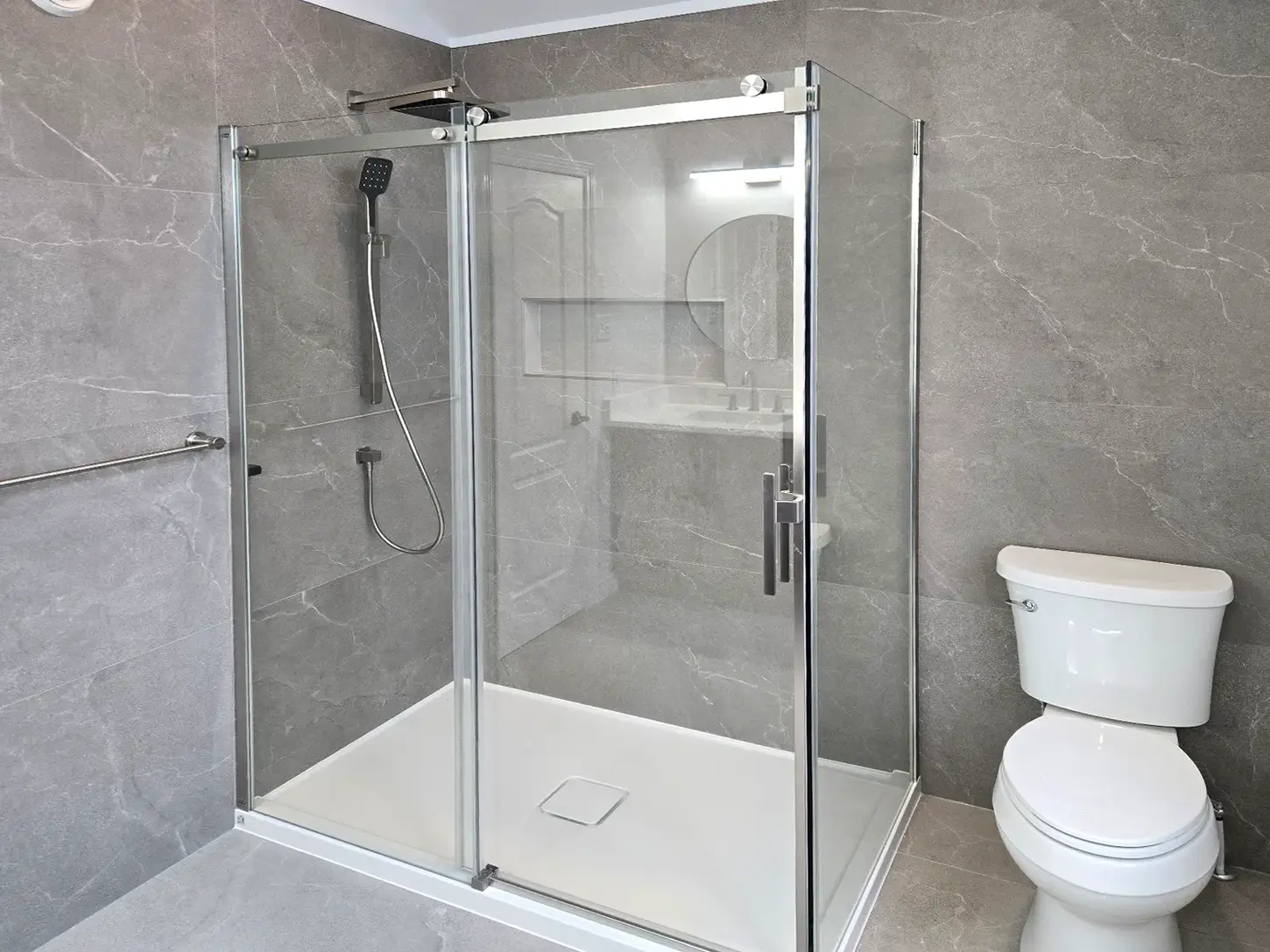 modern shower remodel chrome fixtures grey tile recessed niche