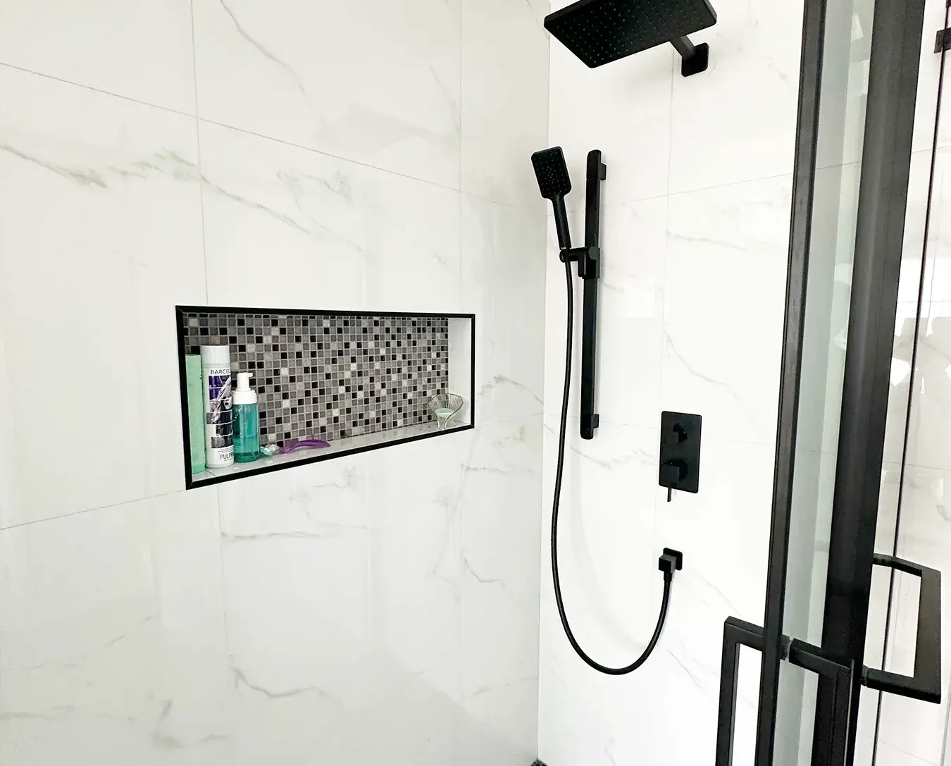 custom shower renovation matte black fixtures mosaic tile niche