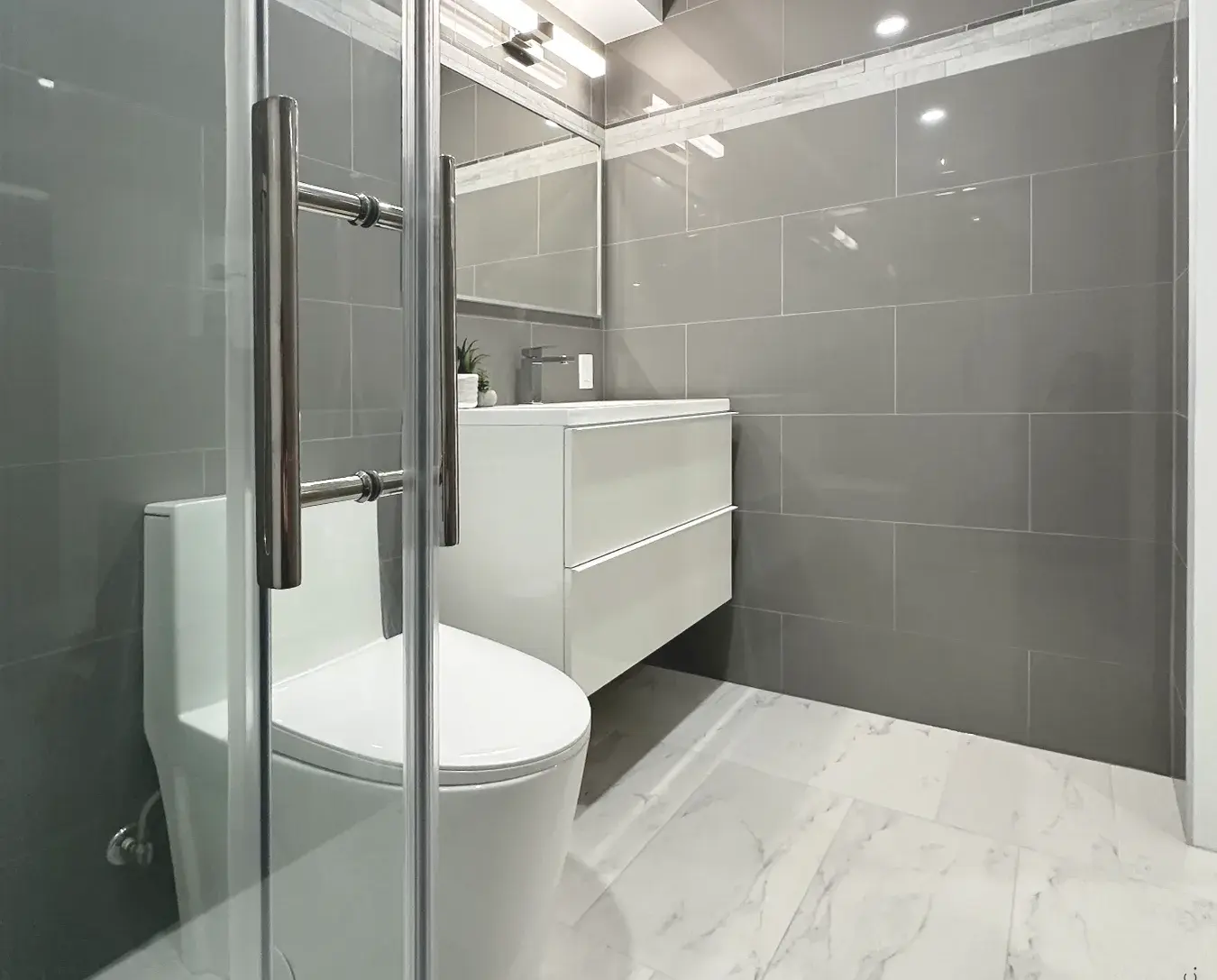 Modern toilet, marble floor tile, floating vanity, gray wall tile