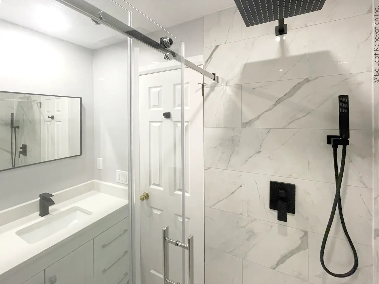 Remodeled bathroom, white vanity, glass shower, black trim