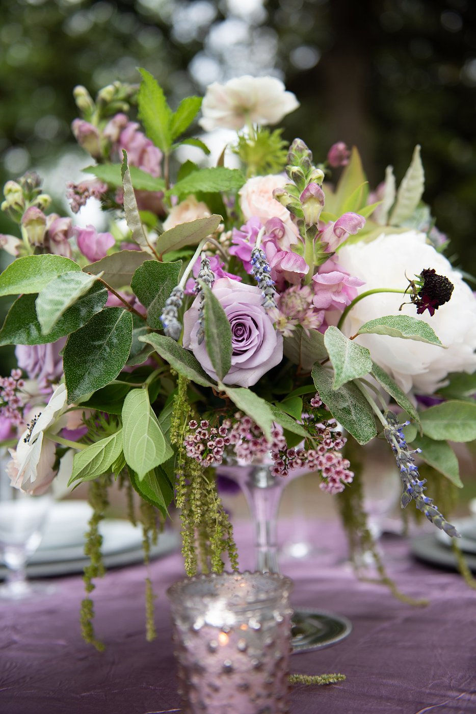 Purple wedding centerpiece with roses