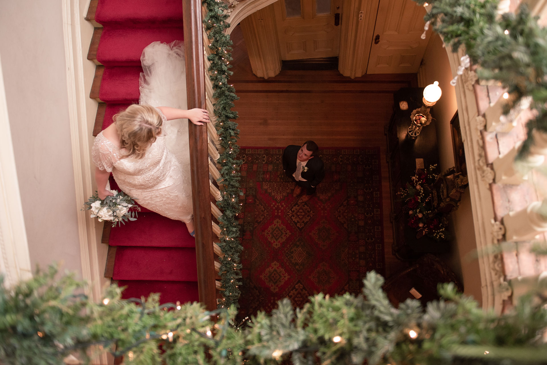 Bride looking at groom from top of stairs