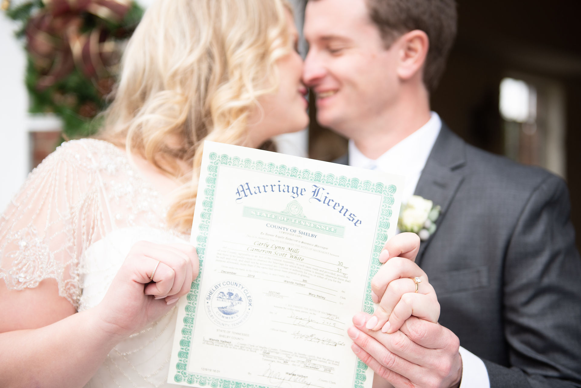 Bride and groom holding marriage license