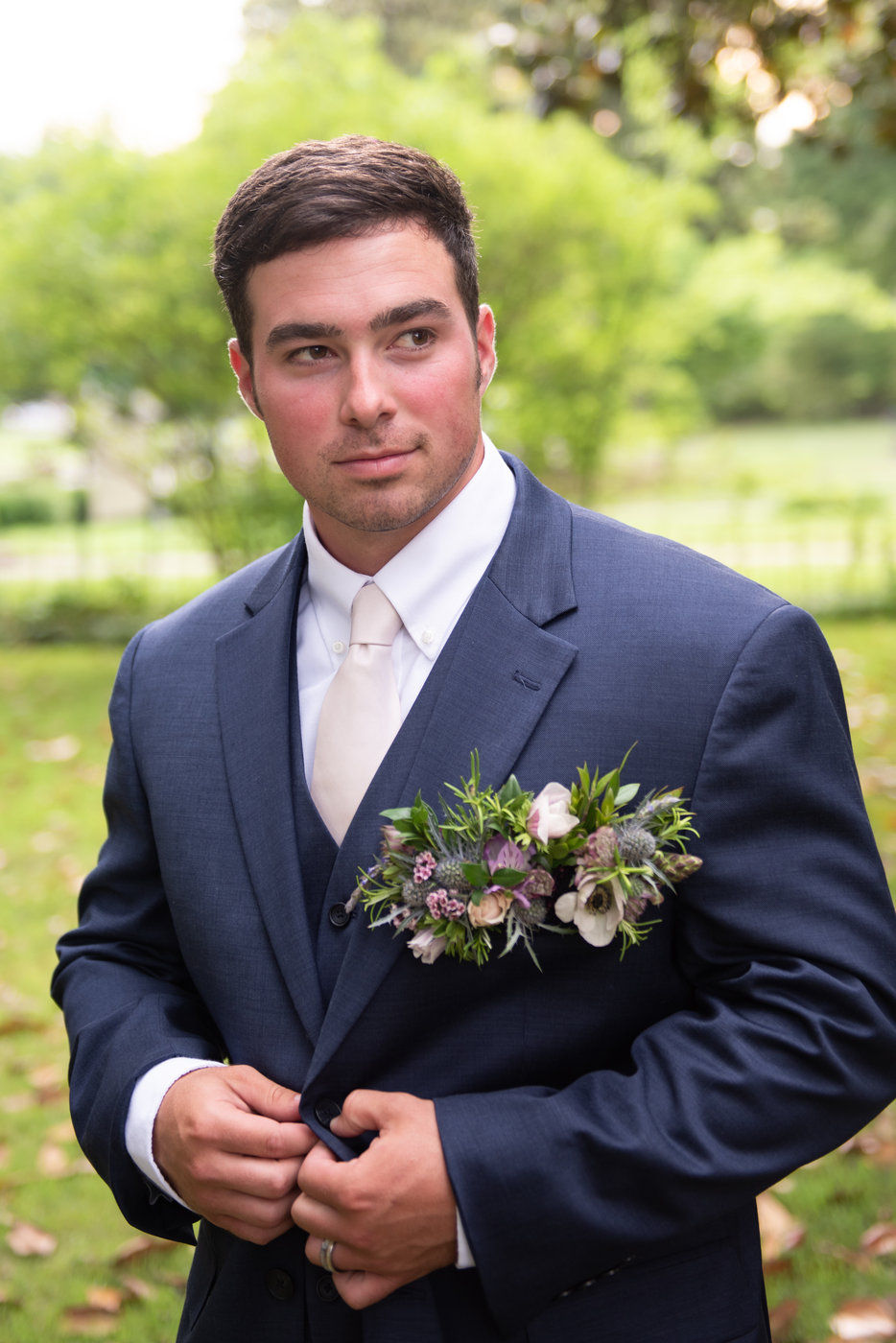 Groom buttoning jacket