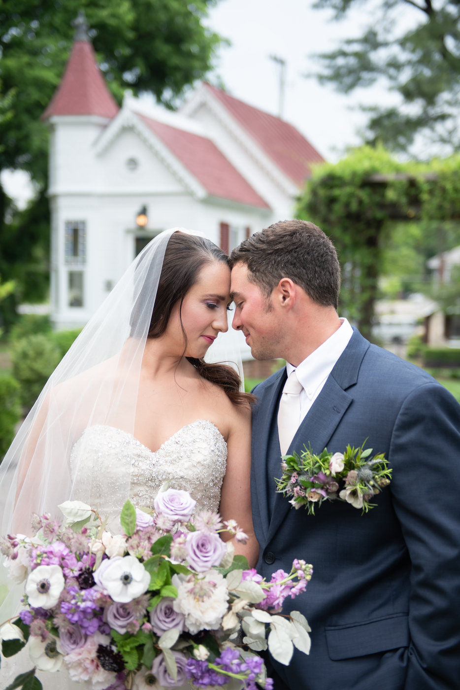Bride and groom holding hands in front of chapel