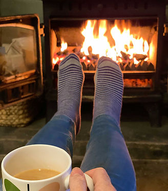 Warming feet in front of a log fire