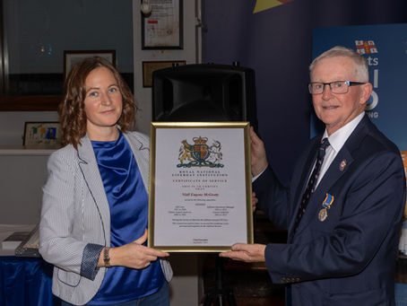 Area operations manager Lisa Hollingum presenting Niall McGrotty with his certificate of service.