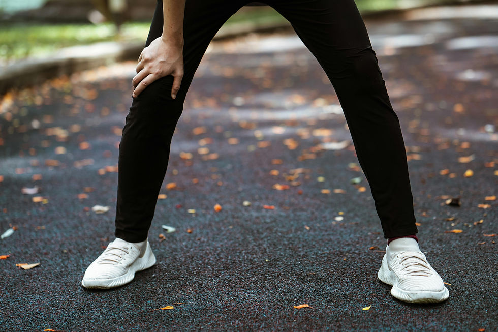 Athlete resting after run with hands on knees