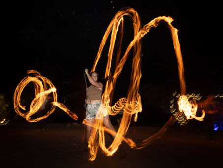 Clara Free Spirit playing with rope dart at a fire jam