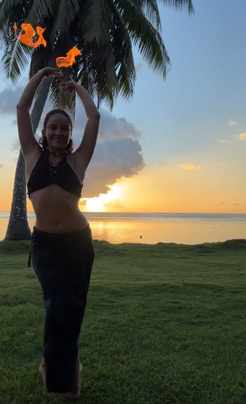Clara Free Spirit intuitive dancing with fire Palm torches on the beach in Tahiti, French Polynesia