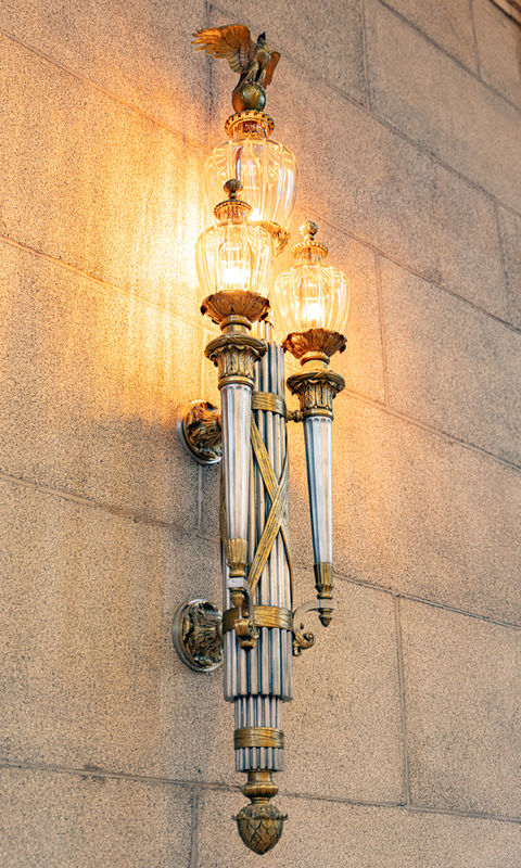 Closeup of ornate silver and brass wall sconce in the main auditorium of the Andrew W. Mellon Auditorium in Washington DC