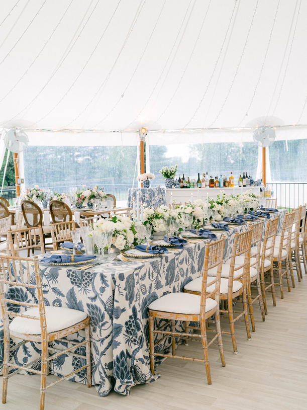 Blue and white wedding tablescape with white florals at outdoor wedding 