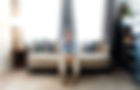 Jamie-Csizmadia-sitting-on-a-couch-in-a-well-lit-living-room_edited.jpg
