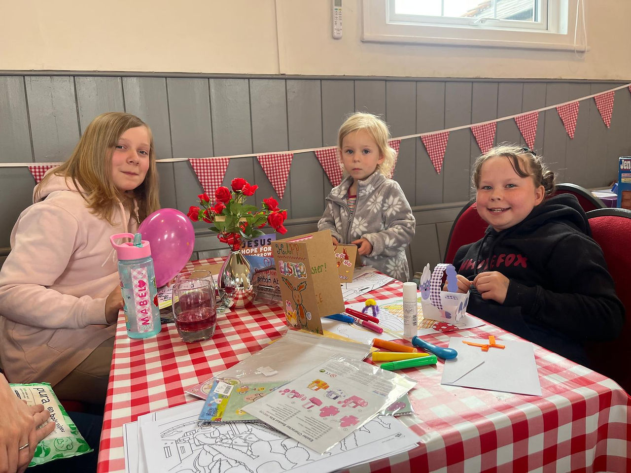 A photo of three children making some crafts