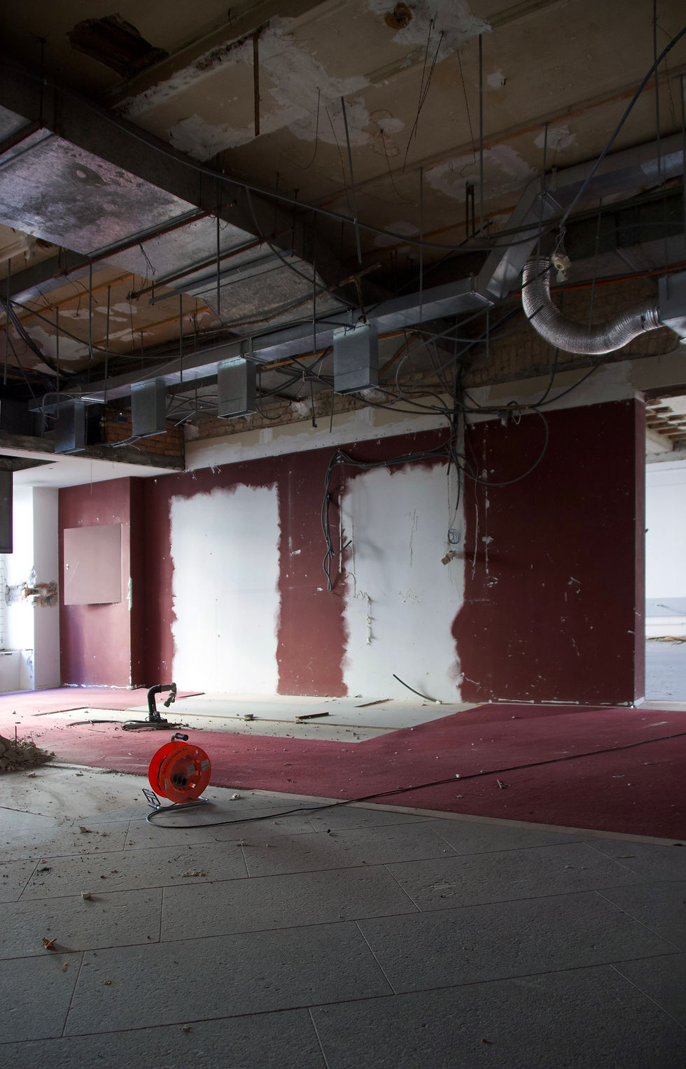 Die einst vornehme Eingangshalle erscheint heute mit entblösster, roher Decke und legt ihre metallenen Lüftungsrohre frei. Übermalte Wände muten künstlerisch an und erinnern an die Kunst von Antoni Tàpies und Mark Rothko.