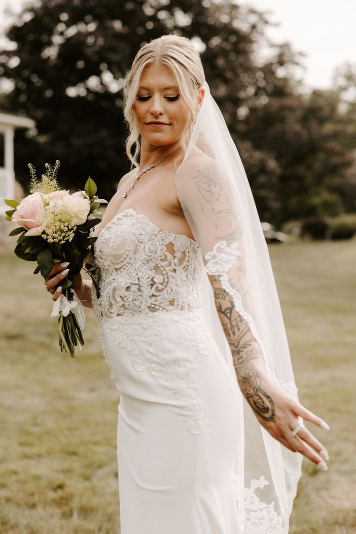 Bride standing in her wedding dress during bridal portraits in Massachusetts.