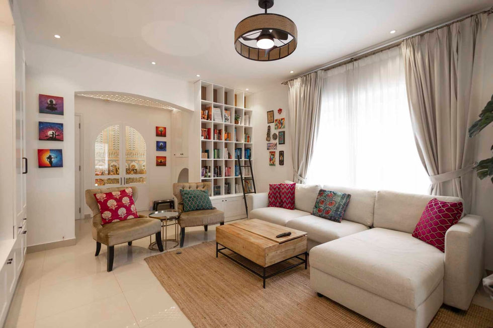 a living room with a white sectional couch and a wooden coffee table